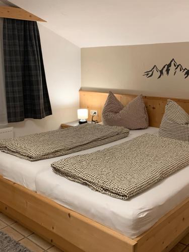 two beds sitting next to each other in a bedroom at Appartement Schmid in Oetz