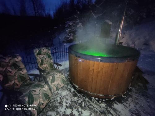 a large wooden barrel with a green substance at Apartamenty u Joli in Wisła