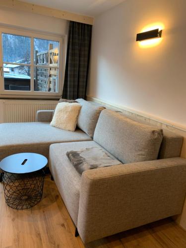 a living room with a couch and a table at Appartement Schmid in Oetz