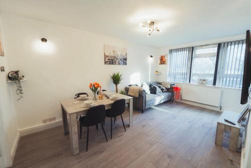a living room with a table and a couch at 1 Bed-Park View-Balcony-WiFi-Pet Friendly in London
