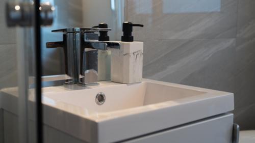 a white sink in a bathroom with a mirror at 1 Bed-Park View-Balcony-WiFi-Pet Friendly in London