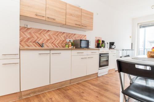 a kitchen with white cabinets and a counter top at Helle Wohnung mit Balkon perfekt für Monteure und Arbeiter in Rüsselsheim