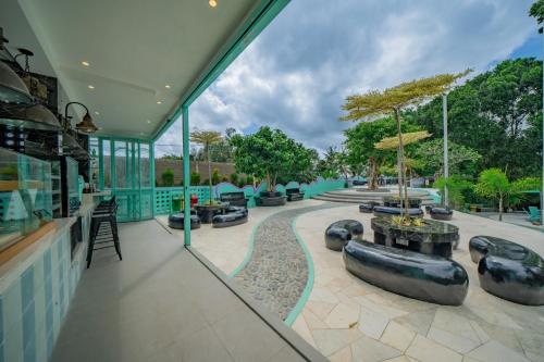 a view of a building with a patio with trees at Toya Ubud Ecopark & Waterfall in Tegalalang