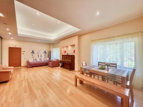 a large living room with a table and a couch at Amazing location next to the beach jomas str in Jūrmala