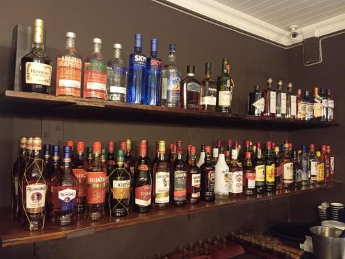 a shelf filled with lots of bottles of alcohol at Cove Rock Lodge on Cowrie in East London