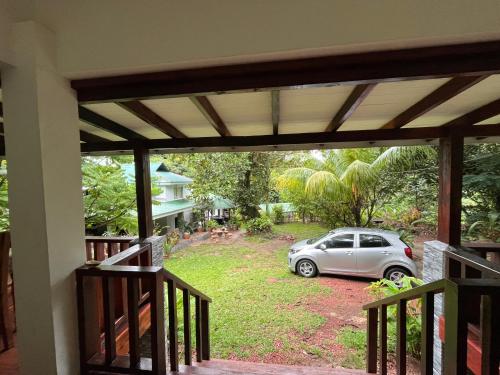 a car parked in a yard outside a house at Blissful hill top Apartment in Anse Possession