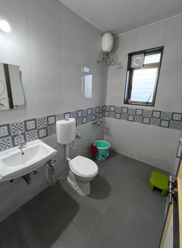 a bathroom with a white toilet and a sink at ShriHari Villa in Panchgani