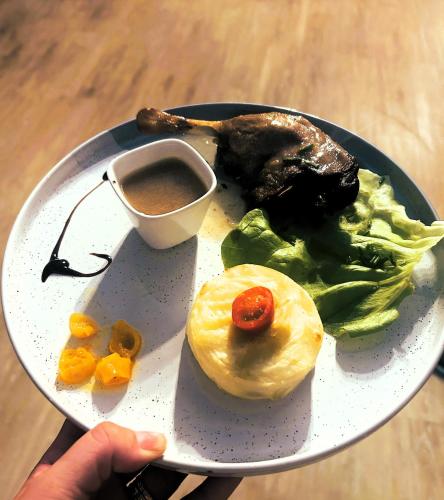 a plate of food with a breakfast of lettuce and eggs at Gabrielle hôtel in Aiguines