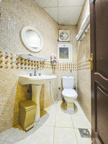 a small bathroom with a sink and a toilet at Jawad Al-Taj Hotel in Mecca