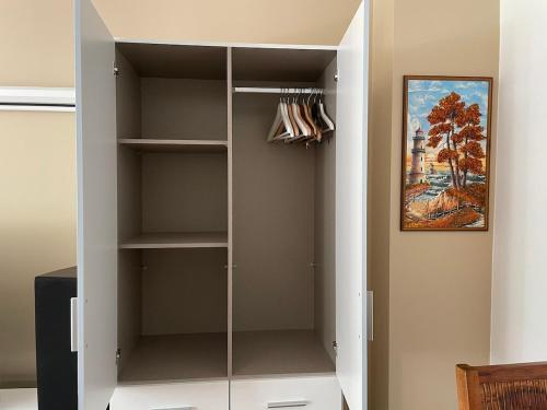 a white closet with glass doors in a room at Modern and cozy apartment in good location in Berlin