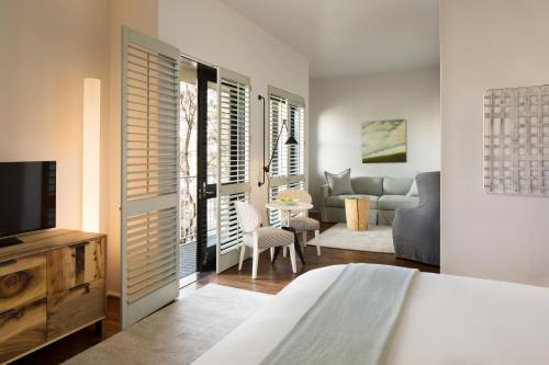 a bedroom with a bed and a living room at Hotel Healdsburg in Healdsburg