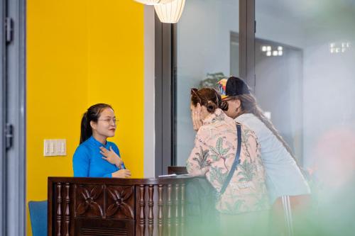 a group of women standing around a table at The Nam An Villa Hoi An in Hoi An