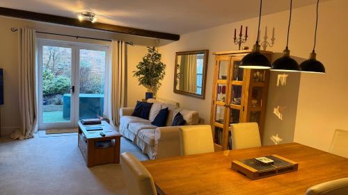 a living room with a couch and a table at The Old Coach House in Stratford-upon-Avon