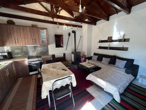 a living room with a bed and a table and a kitchen at Despo's Guest House in Kandíla