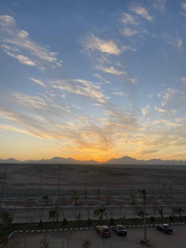 a sunset over a parking lot with cars in a parking lot at Sky Star Hotel free shuttle to Hurghada City center in Hurghada