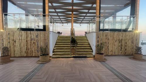 a set of stairs in a building with potted plants at Sky Star Hotel free shuttle to Hurghada City center in Hurghada