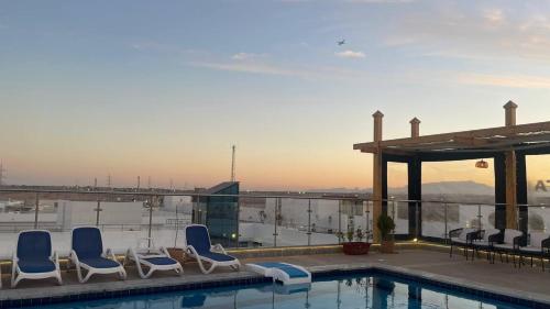 a group of chairs sitting next to a swimming pool at Sky Star Hotel free shuttle to Hurghada City center in Hurghada