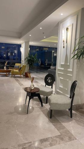 a lobby with a table and chairs and a living room at Sky Star Hotel free shuttle to Hurghada City center in Hurghada