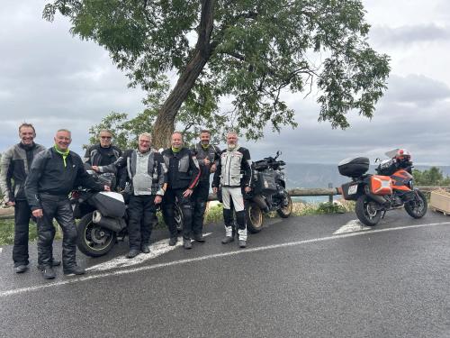 a group of men standing next to motorcycles on a road at Gabrielle hôtel in Aiguines