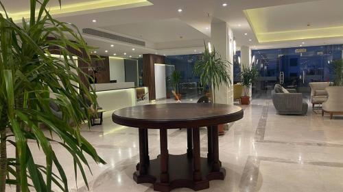 a round table in a lobby with plants at Sky Star Hotel free shuttle to Hurghada City center in Hurghada