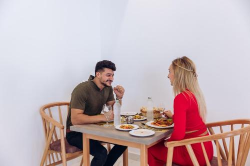 a man and woman sitting at a table eating food at Sky Star Hotel free shuttle to Hurghada City center in Hurghada