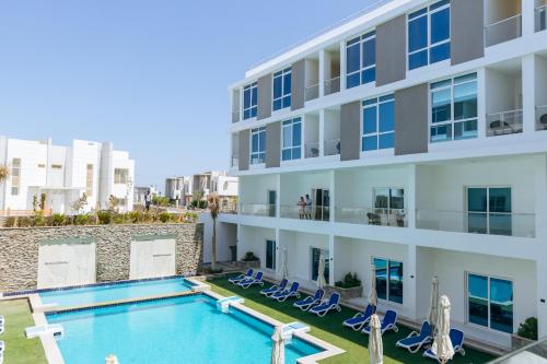 an image of an apartment building with a swimming pool at Sky Star Hotel free shuttle to Hurghada City center in Hurghada