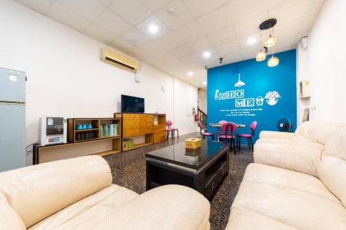 a living room with white furniture and a blue wall at 日月潭水里東方海悅輕旅包棟 in Shuili