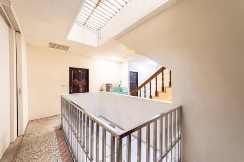 a hallway with a white staircase with a skylight at 日月潭水里東方海悅輕旅包棟 in Shuili