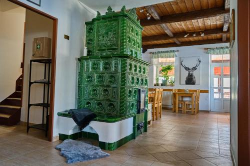 a green tower in the middle of a room at Pension Korýtko in Horská Kvilda