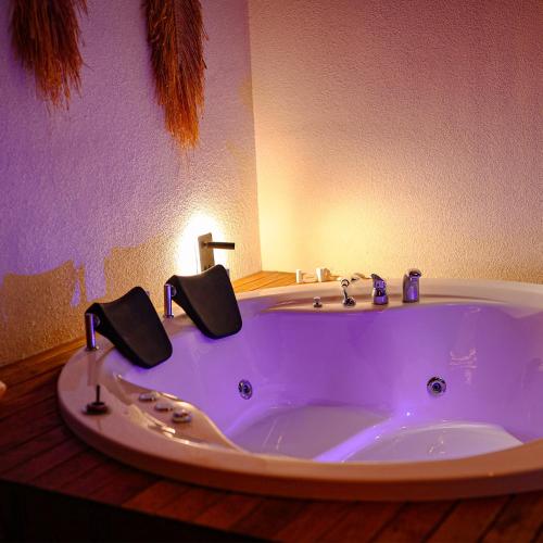 a bathroom with a large white tub with two faucets at Grand Paradise Resort Sapanca in Sapanca