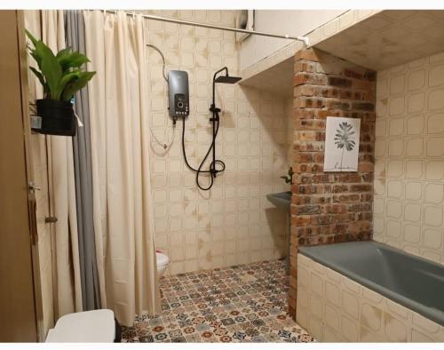 a bathroom with a bath tub and a toilet at Soho Stay in Kuala Terengganu