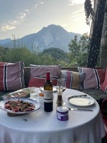 a table with a plate of food and a bottle of wine at les chalets de Maryline in Accous