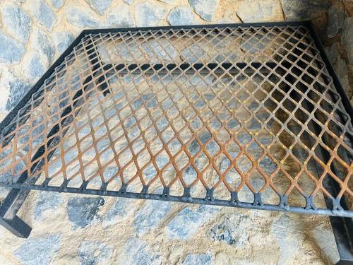 a metal grill sitting on top of a stone wall at Homely Stay 3 in Kempton Park