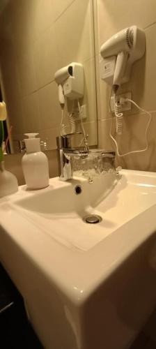 a white sink in a bathroom with a mirror at CB Suite Homes in Mandurriao