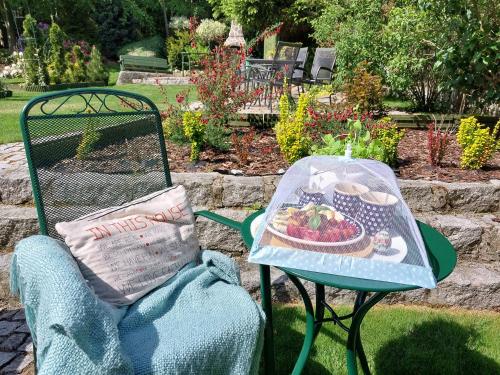 a chair with a table with a plate of food on it at Szymonówka W Szklarskiej Porębie in Szklarska Poręba