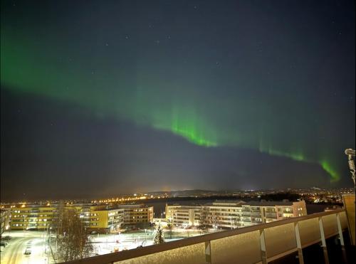 an image of the aurora in the sky over a city at Penthouse in the city center in Rovaniemi