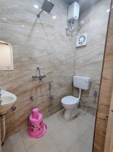 a bathroom with a toilet and a sink at A ShivAngan Heritage Home Stay Near Ghat in Varanasi