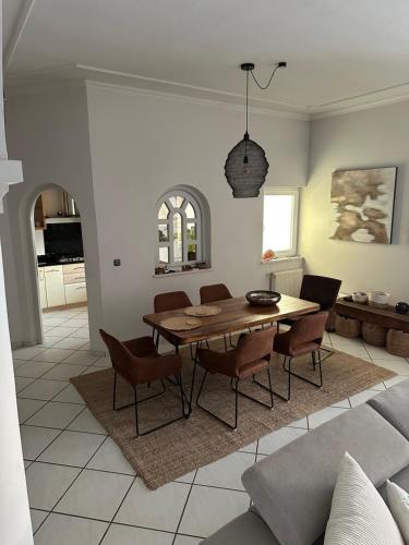 a living room with a wooden table and chairs at Apartments Jareb in Tribunj