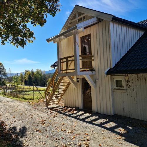 a tiny house with a staircase on the side at Småbruk in Fyresdal