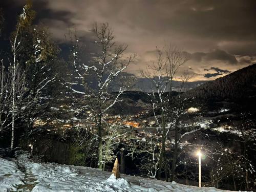 a person standing on a snow covered slope with a city at Positive vibes in Visoko