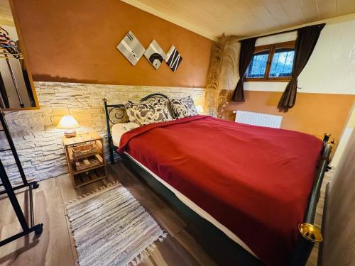 a bedroom with a red bed in a room at Moselle Magic in Stadtbredimus