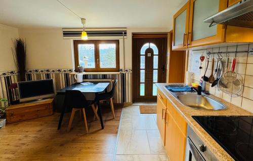a kitchen with a table and a dining room at Moselle Magic in Stadtbredimus