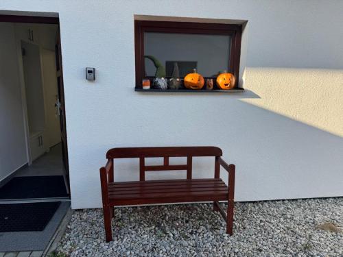 a bench on a wall with pumpkins on a shelf at Free Spirit in Nová Pec