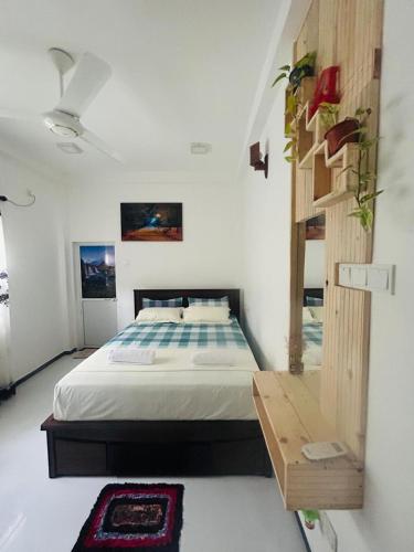 a bedroom with a bed in a white room at Nisha Grean Heaven in Weligama