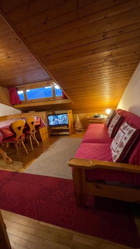 a bedroom with a bed and a table in a room at Attico Vista Tofane in Cortina dʼAmpezzo
