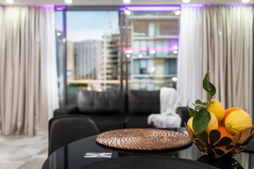 a room with a table with a bowl of fruit on it at Central Luxury 3BR Apartment for up to 8 Guests in Melbourne