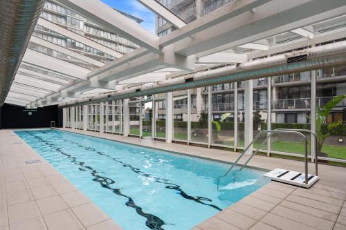 an indoor swimming pool in a building at Central Luxury 3BR Apartment for up to 8 Guests in Melbourne