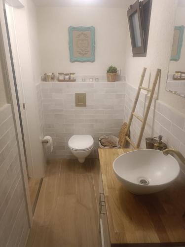 a bathroom with a white sink and a toilet at קאסה לונה casa luna in Gan Yavneh
