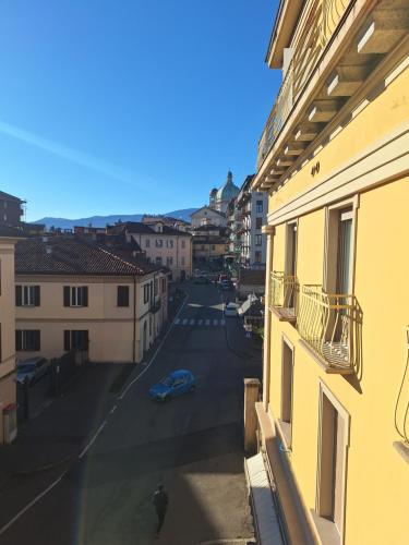 a view of a street from a balcony of a building at Chic Brand New Apartment at Palazzo Giuliani in Verbania in Intra