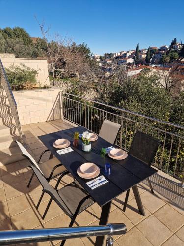 a black table and chairs sitting on a balcony at Solentia in Stomorska